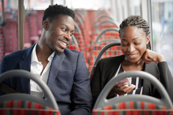 two business partners ride to work on a shuttle bus