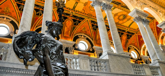 a statue and marble columns in the Library of Congress in Washington DC