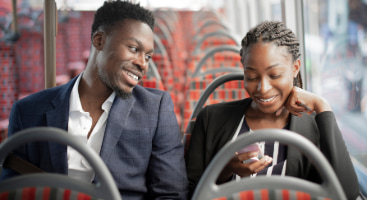 two business partners ride to work on a shuttle bus